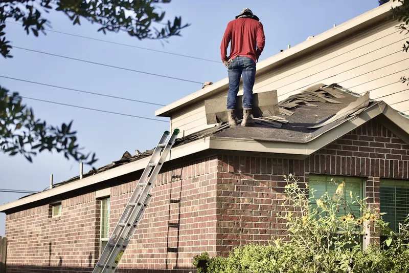 Professional roofer working on a residential roof in East Alton